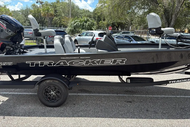 The Image of 2027 Tracker Pro Team 190 boat parked outdoors, featuring sleek black design and modern seating. - 0