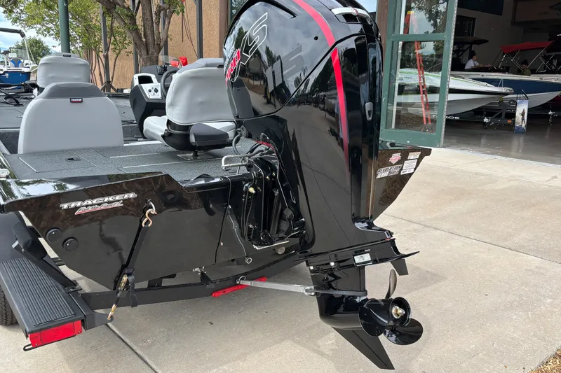 Slide: The Image of 2027 Tracker Pro Team 190 boat with sleek black exterior and powerful outboard motor. - 13