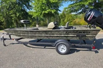 The Image of 2027 Tracker Grizzly 1754 SC boat on trailer, parked outdoors. - 0