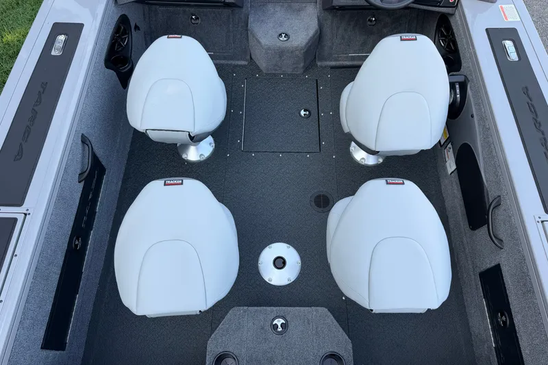 Slide: The Image of 2027 Tracker Targa V-18 Combo boat interior with four white seats. - 14