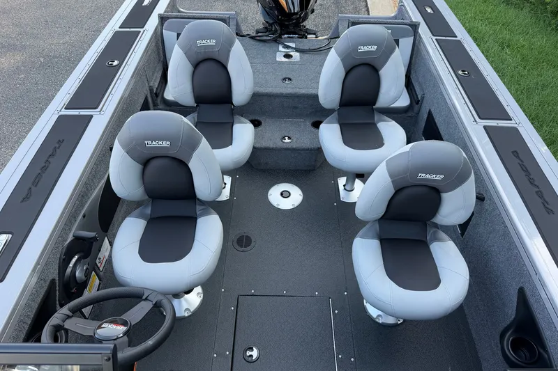 Slide: The Image of 2027 Tracker Targa V-18 Combo boat interior with four gray seats and steering wheel. - 15