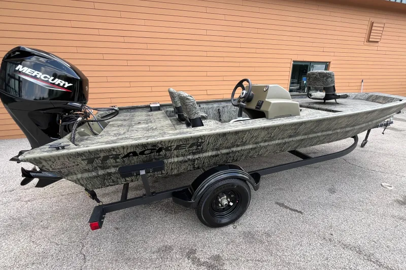 The Image of 2027 Tracker Grizzly 1754 SC boat with Mercury engine on trailer, parked outdoors. - 0