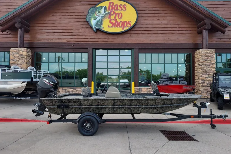 The Image of 2027 Tracker Grizzly 1754 SC boat displayed outside Bass Pro Shops store. - 0