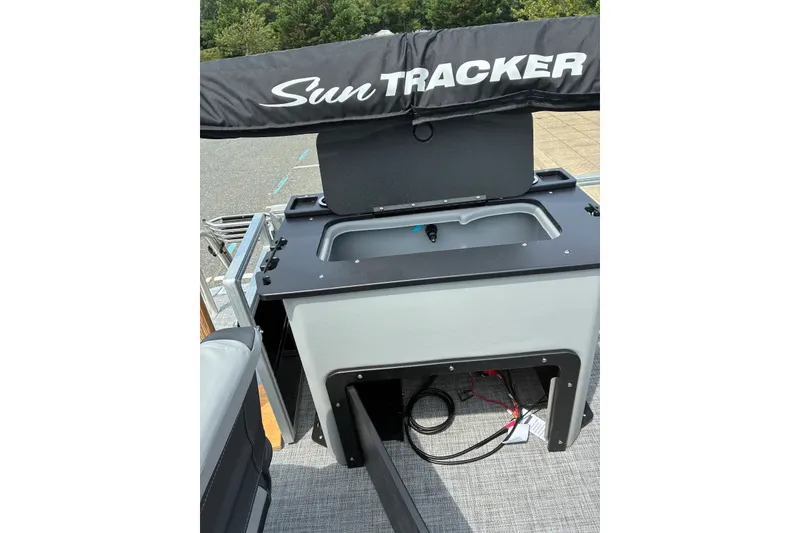 Slide: The Image of Sun Tracker SportFish 22 DLX 2027 boat interior with storage compartment and cover. - 16
