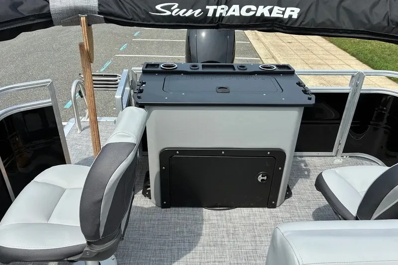 Slide: The Image of 2027 Sun Tracker SportFish 22 DLX boat interior with seating and storage area. - 15