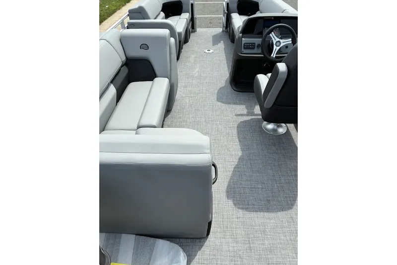 Slide: The Image of 2027 Sun Tracker SportFish 22 DLX interior with gray seating and modern helm. - 19