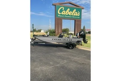 The Image of 2027 Tracker Pro 170 boat parked outside Cabela's store under clear blue sky. - 0