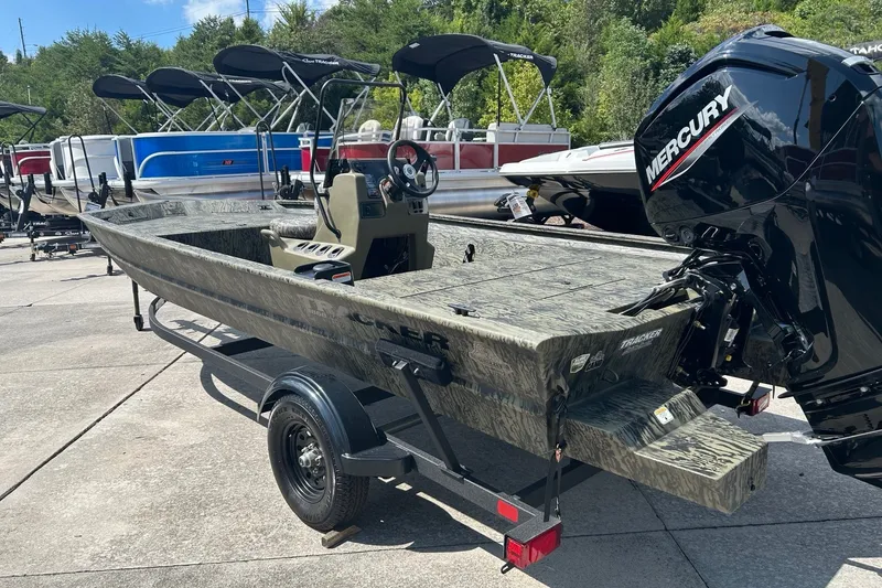 The Image of 2027 Tracker Grizzly 1860 CC boat with Mercury engine on trailer, parked outdoors. - 0