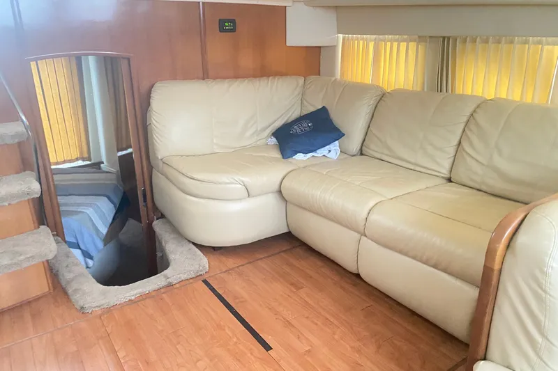 Slide: The Image of Interior of 2006 Carver 41 Cockpit Motor Yacht with beige leather seating and wooden flooring. - 13