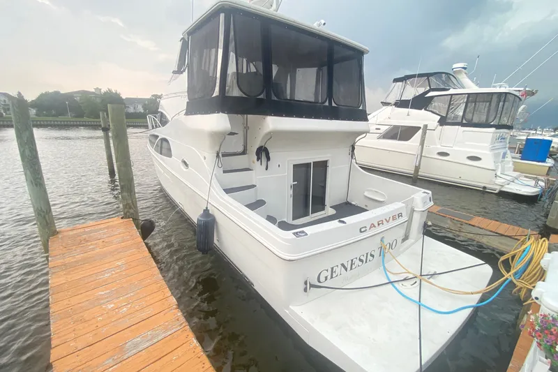 The Image of 2006 Carver 41 Cockpit Motor Yacht docked at marina, rear view. - 0