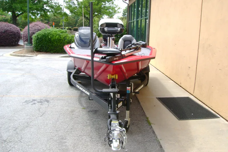 Slide: The Image of 2027 Tracker Pro Team 195 boat on trailer, parked outdoors near a building. - 37
