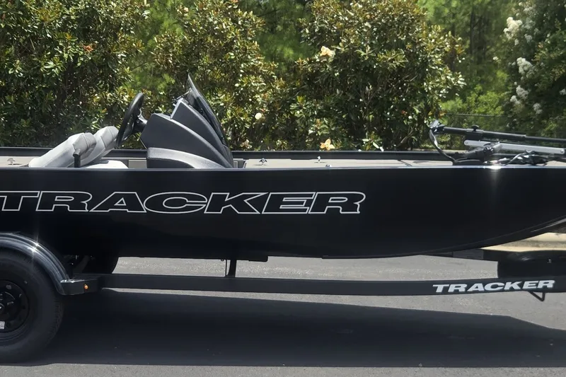 The Image of 2027 Tracker Pro 170 boat on trailer, sleek black design, parked outdoors. - 0