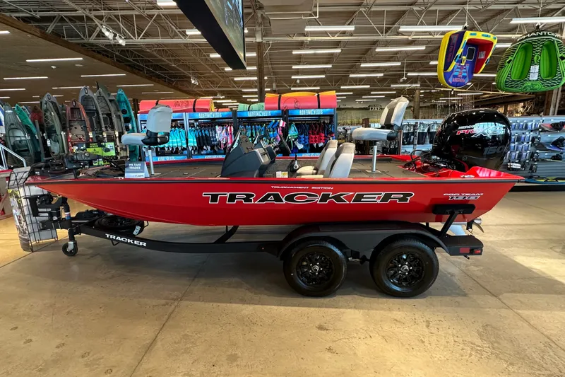 The Image of 2027 Tracker Pro Team 195 boat displayed in a showroom with vibrant accessories. - 27