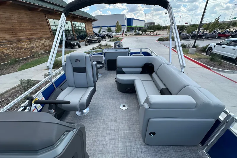 Slide: The Image of 2027 Sun Tracker SportFish 22 DLX pontoon boat with gray seating and canopy. - 16