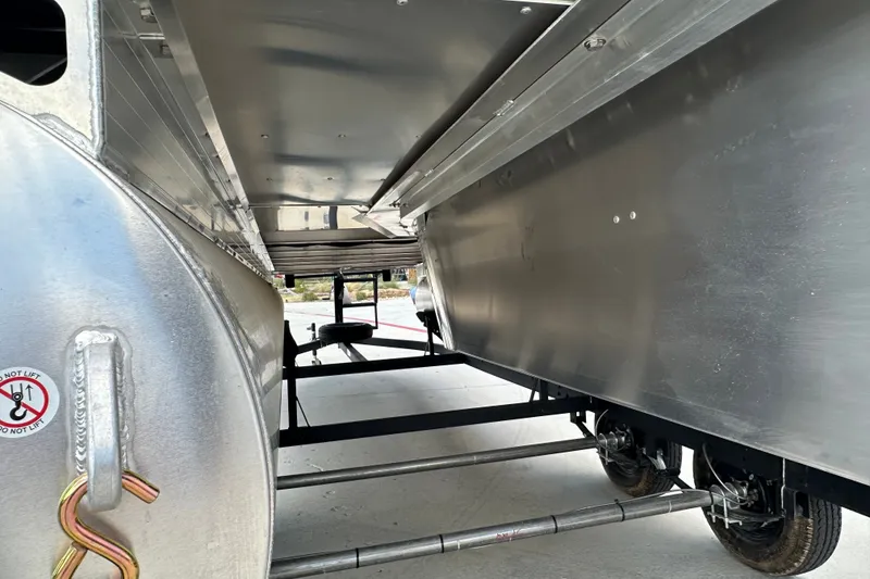 Slide: The Image of Underneath view of 2027 Sun Tracker SportFish 22 DLX pontoon boat on trailer. - 13