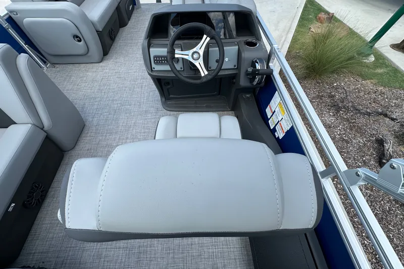Slide: The Image of 2027 Sun Tracker SportFish 22 DLX boat interior with steering wheel and seating. - 20