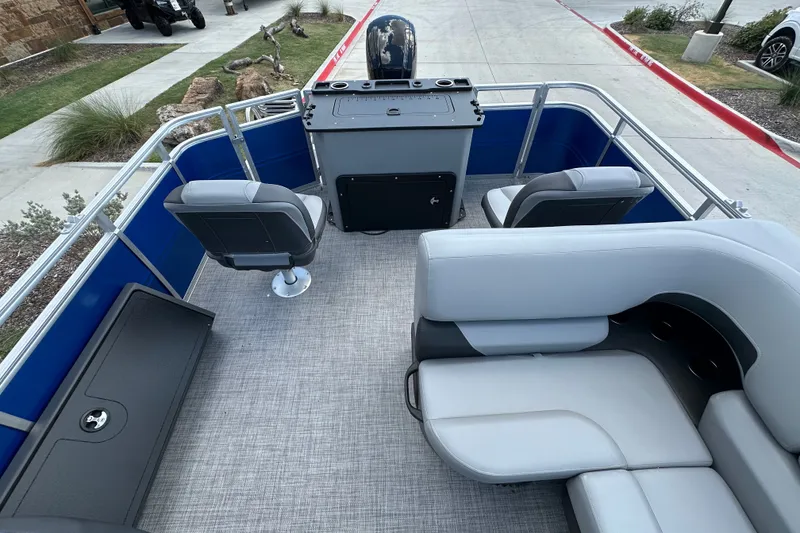 Slide: The Image of 2027 Sun Tracker SportFish 22 DLX pontoon boat interior with seating and helm station. - 17
