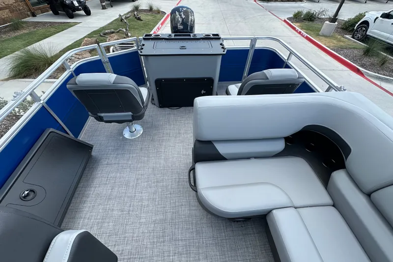 Slide: The Image of 2027 Sun Tracker SportFish 22 DLX pontoon boat interior with seating and helm. - 22