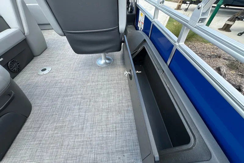 Slide: The Image of Interior view of 2027 Sun Tracker SportFish 22 DLX boat, featuring seating and storage compartment. - 18