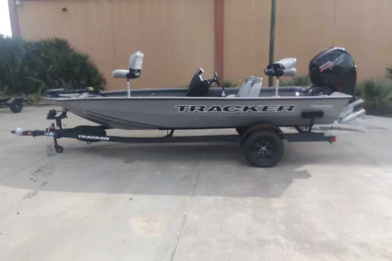 The Image of 2027 Tracker Pro Team 195 fishing boat on trailer, parked outdoors. - 0