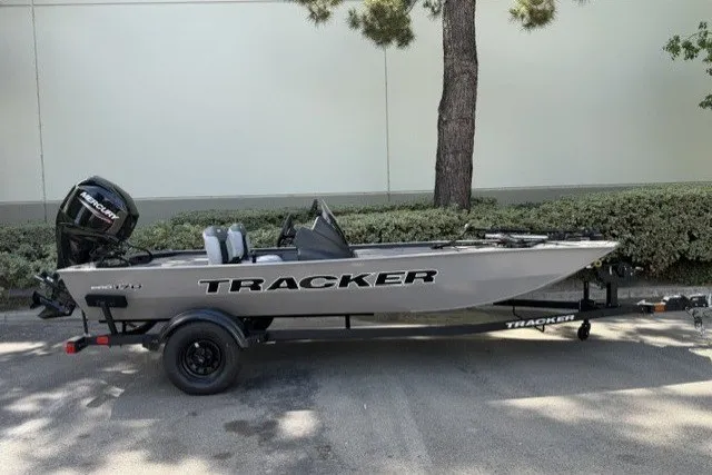 The Image of 2027 Tracker Pro 170 boat on trailer, parked outdoors near trees. - 0