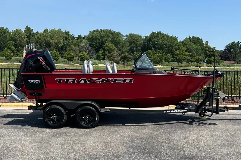 The Image of 2027 Tracker Targa V-18 Combo boat on trailer, red exterior, parked outdoors. - 0