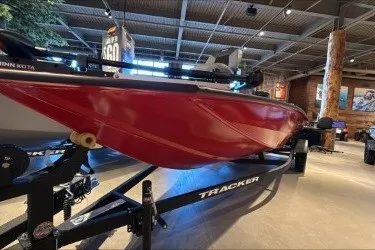 The Image of 2027 Tracker Pro Team 190 boat in showroom, red hull on trailer. - 0