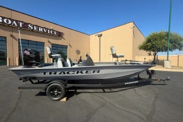 The Image of 2027 Tracker Pro Team 190 boat parked outside a service center on a sunny day. - 0