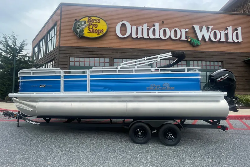 The Image of 2027 Sun Tracker SportFish 22 DLX pontoon boat outside Bass Pro Shops Outdoor World. - 0