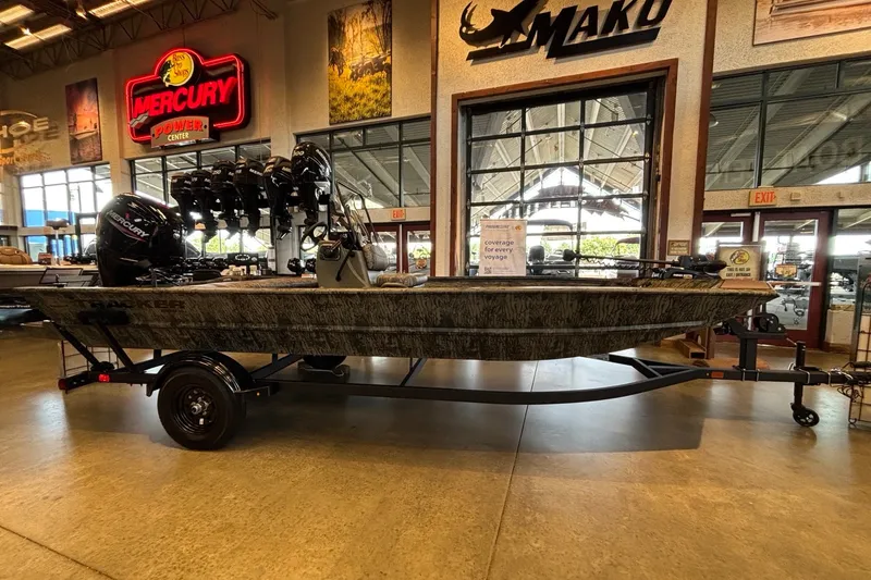 The Image of 2027 Tracker Grizzly 1860 CC boat displayed indoors with Mercury engine. - 0