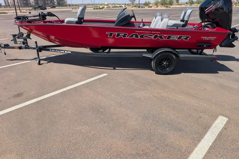 The Image of Red 2027 Tracker Pro Team 190 boat on trailer in parking lot. - 0