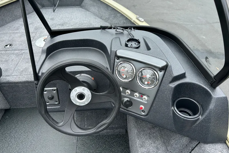 Slide: The Image of 2027 Tracker Pro Guide V-16 WT boat dashboard with steering wheel and gauges. - 23