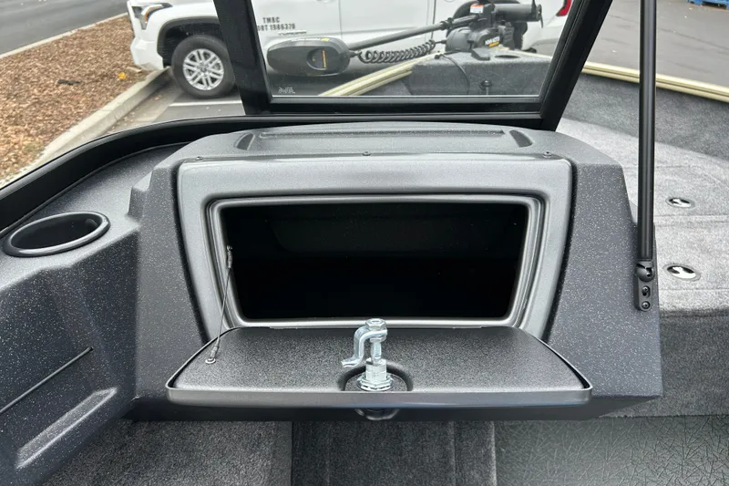 Slide: The Image of 2027 Tracker Pro Guide V-16 WT boat storage compartment with open lid and cup holder. - 25