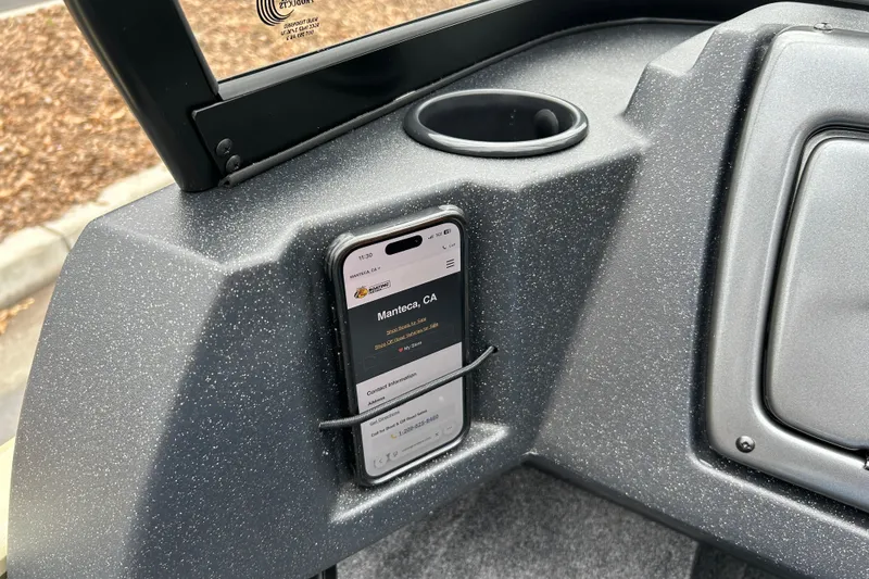 Slide: The Image of Dashboard of 2027 Tracker Pro Guide V-16 WT with phone holder and cup holder. - 28