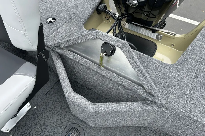 Slide: The Image of 2027 Tracker Pro Guide V-16 WT boat interior with gray carpet and seating. - 32