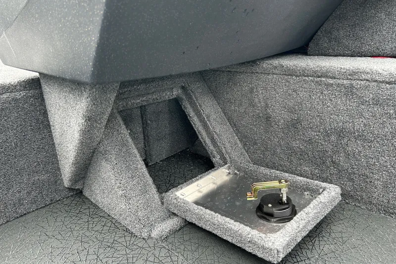 Slide: The Image of Interior view of 2027 Tracker Pro Guide V-16 WT boat, featuring a carpeted compartment. - 30
