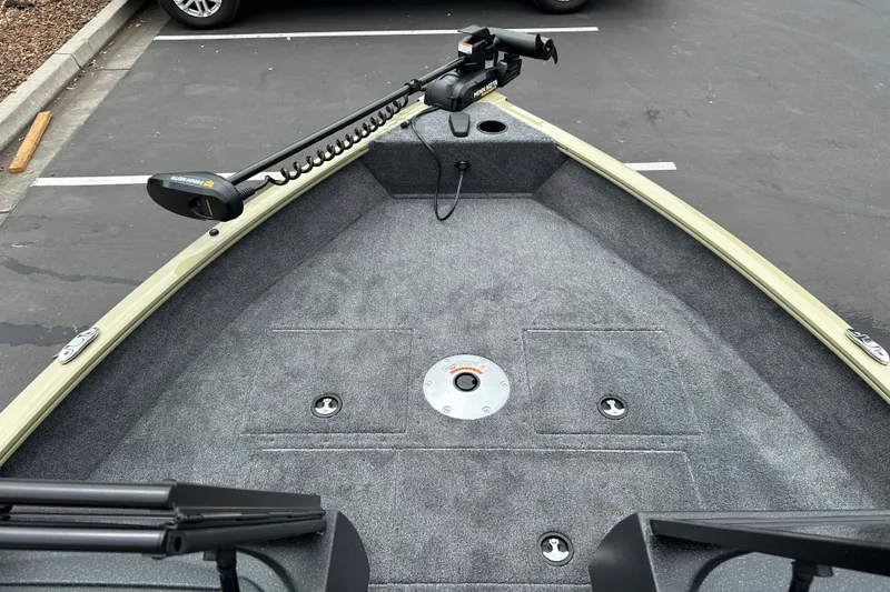 Slide: The Image of 2027 Tracker Pro Guide V-16 WT boat deck with trolling motor in parking lot. - 15