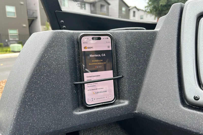 Slide: The Image of Smartphone in a 2027 Tracker Pro Guide V-16 WT boat dashboard holder. - 27