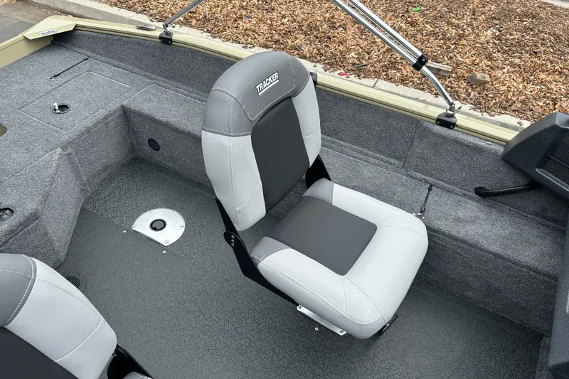 Slide: The Image of 2027 Tracker Pro Guide V-16 WT boat interior with gray seating and carpeted flooring. - 18