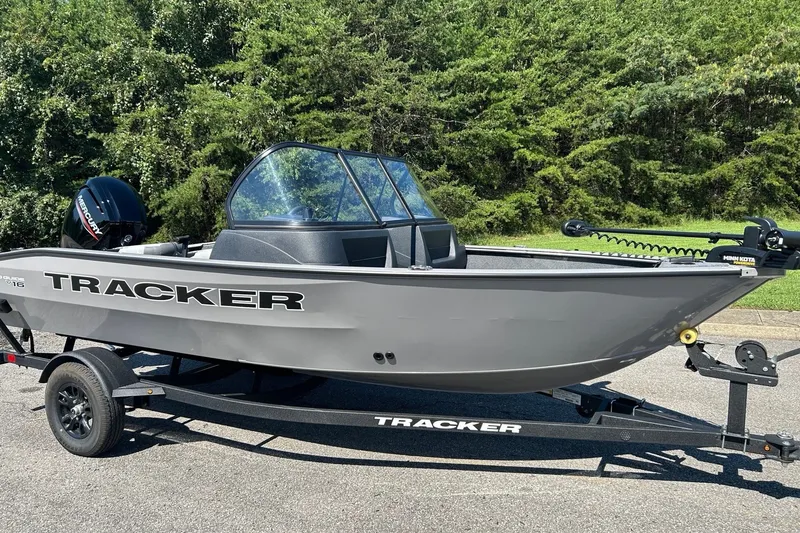 The Image of 2027 Tracker Pro Guide V-16 WT boat on trailer, parked outdoors. - 0