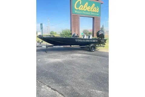 The Image of 2027 Tracker Pro Team 190 boat parked outside Cabela's store. - 0