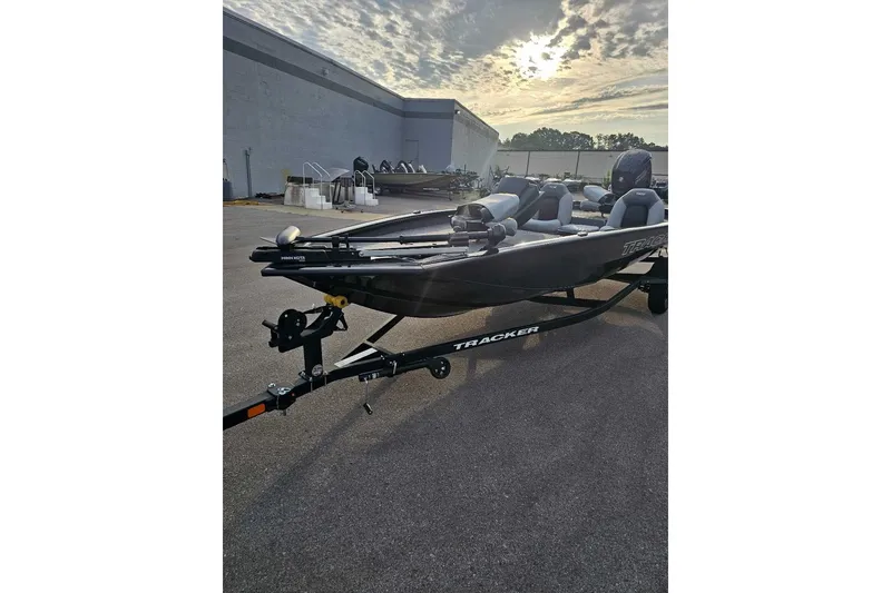 The Image of 2027 Tracker Pro Team 190 boat on trailer under cloudy sky. - 0