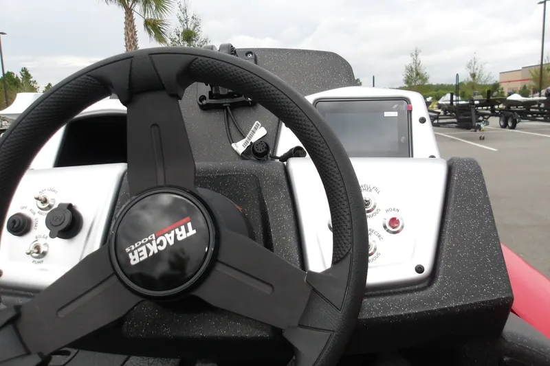Slide: The Image of 2027 Tracker Pro Team 190 boat dashboard with steering wheel and control panel. - 16