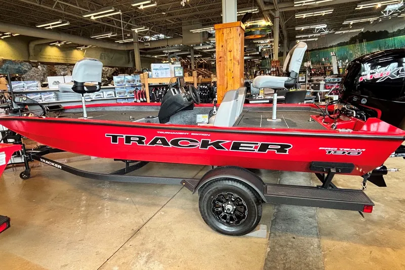 The Image of 2027 Tracker Pro Team 190 boat displayed indoors, featuring a vibrant red design. - 0