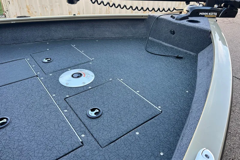 Slide: The Image of 2027 Tracker Pro Guide V-16 WT boat deck with storage compartments and Minn Kota motor. - 15