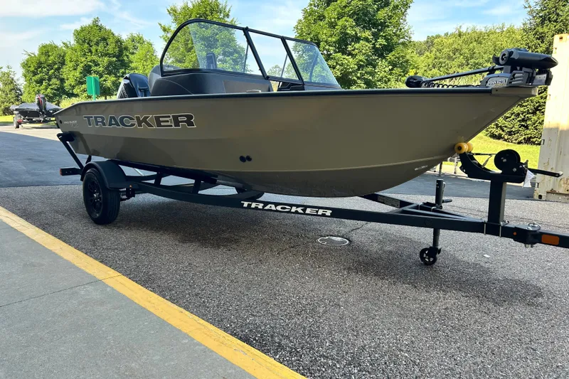 The Image of 2027 Tracker Pro Guide V-16 WT boat on trailer, parked outdoors. - 0