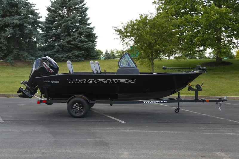 The Image of 2027 Tracker Pro Guide V-16 WT boat on trailer, parked outdoors. - 0