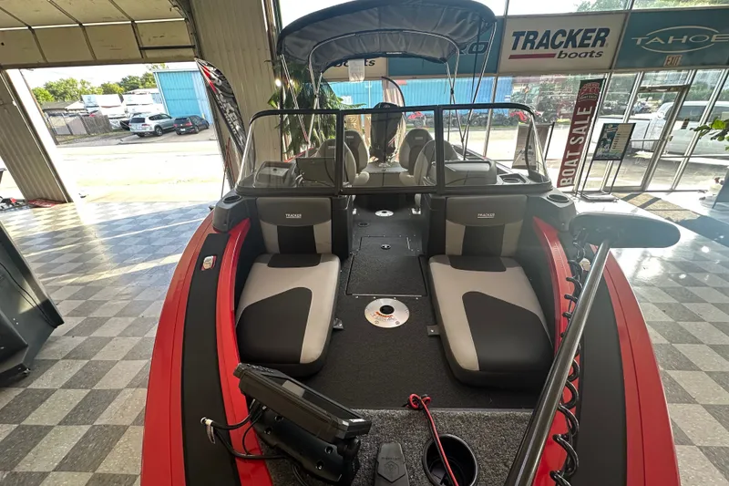 Slide: The Image of 2027 Tracker Targa V-18 Combo boat interior, showroom display with seating and equipment. - 13