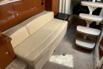 Slide: The Image of Interior of 2008 Sea Ray Sundancer 310 with beige sofa and carpeted steps. - 11