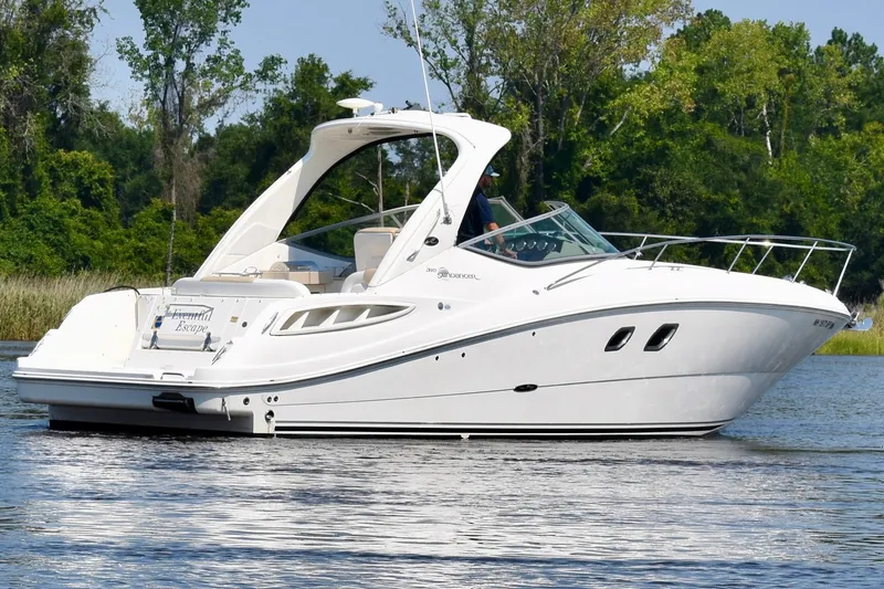 Slide: The Image of 2008 Sea Ray Sundancer 310 cruising on a serene lake with lush green trees in the background. - 7